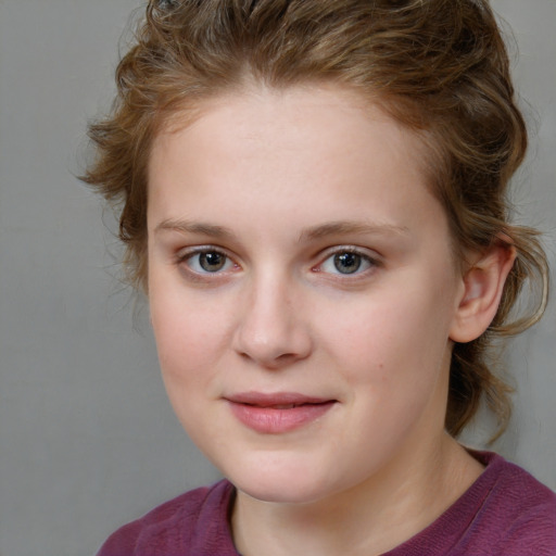 Joyful white child female with medium  brown hair and grey eyes