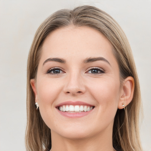 Joyful white young-adult female with long  brown hair and grey eyes