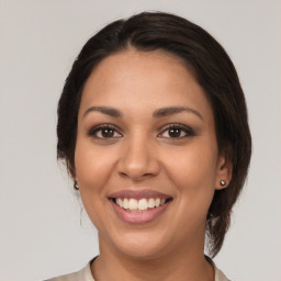 Joyful latino young-adult female with medium  brown hair and brown eyes