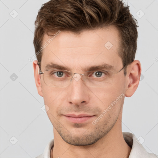 Joyful white young-adult male with short  brown hair and grey eyes