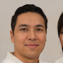 Joyful asian young-adult male with short  brown hair and brown eyes