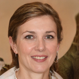 Joyful white adult female with medium  brown hair and grey eyes