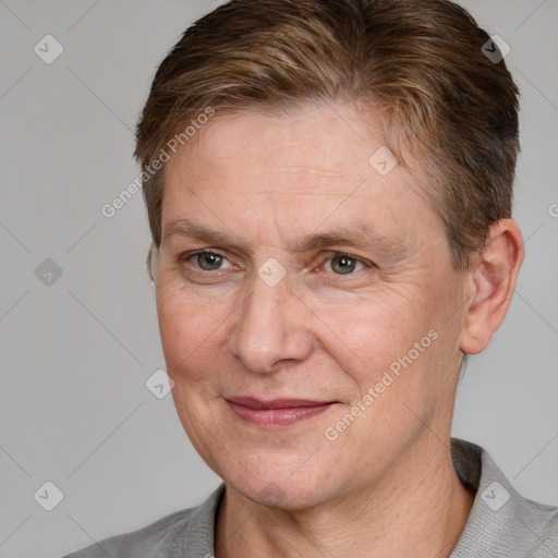 Joyful white adult female with short  brown hair and grey eyes