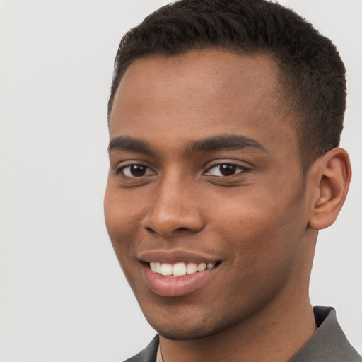 Joyful black young-adult male with short  brown hair and brown eyes