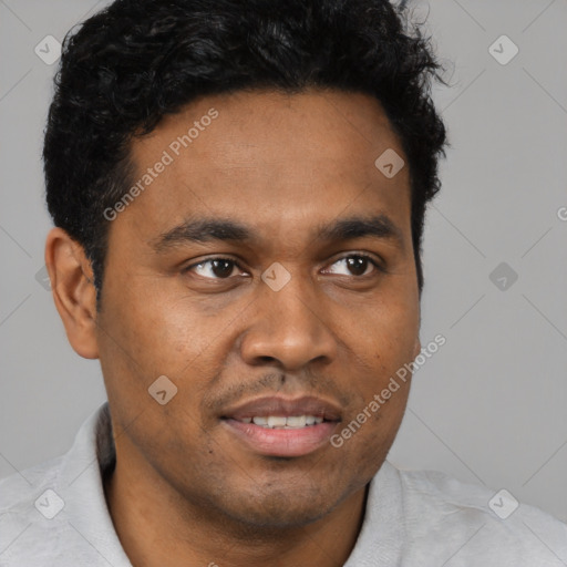 Joyful black young-adult male with short  brown hair and brown eyes