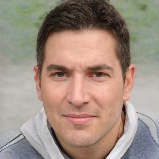 Joyful white adult male with short  brown hair and brown eyes