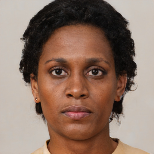 Neutral black young-adult female with short  brown hair and brown eyes