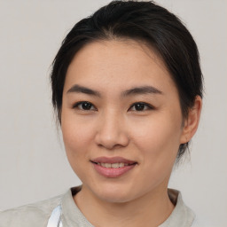 Joyful asian young-adult female with medium  brown hair and brown eyes