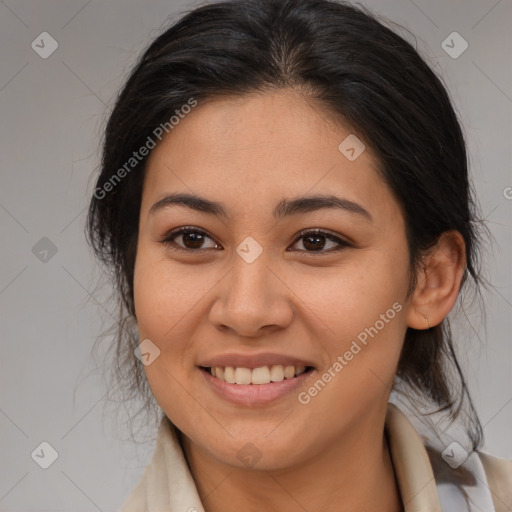 Joyful latino young-adult female with medium  brown hair and brown eyes