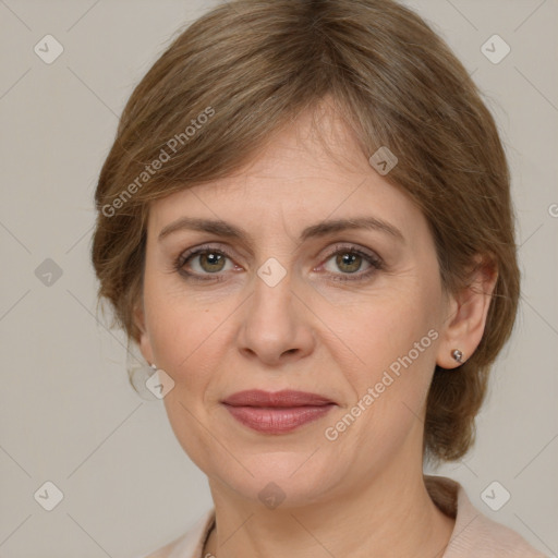 Joyful white adult female with medium  brown hair and green eyes