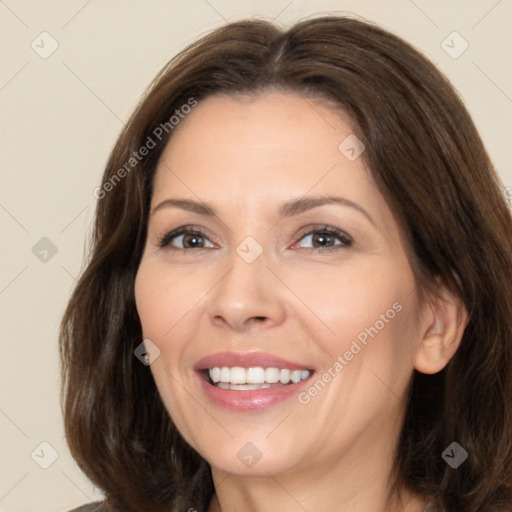 Joyful white adult female with long  brown hair and brown eyes