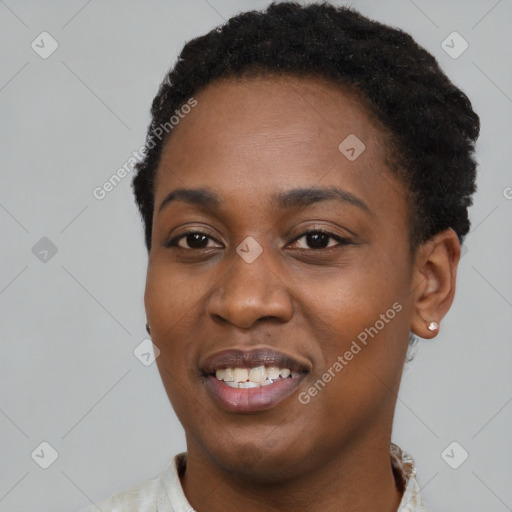 Joyful black young-adult female with short  black hair and brown eyes