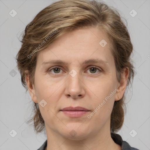 Joyful white adult female with medium  brown hair and grey eyes