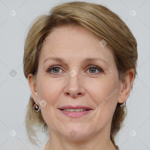 Joyful white adult female with medium  brown hair and grey eyes