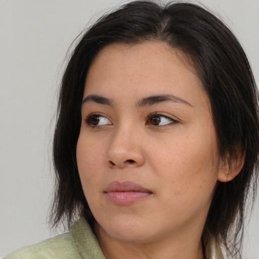 Joyful asian young-adult female with long  brown hair and brown eyes