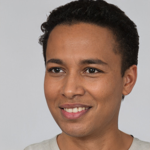 Joyful black young-adult male with short  brown hair and brown eyes