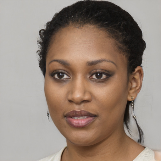 Joyful black young-adult female with short  brown hair and brown eyes