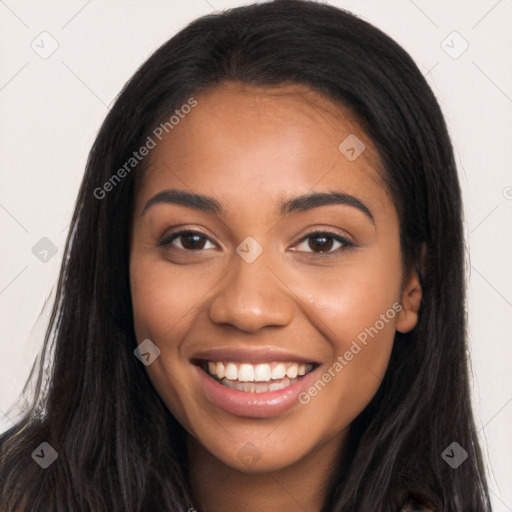 Joyful latino young-adult female with long  black hair and brown eyes