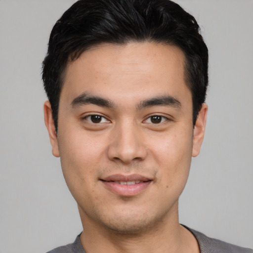 Joyful asian young-adult male with short  black hair and brown eyes
