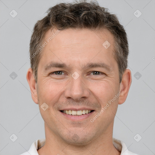 Joyful white adult male with short  brown hair and brown eyes