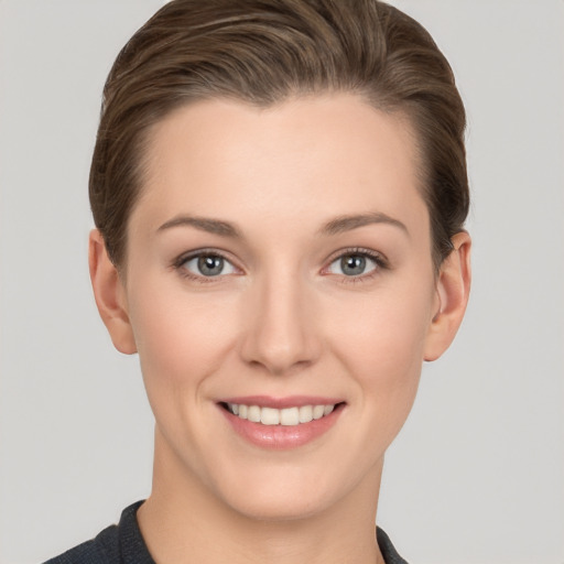 Joyful white young-adult female with short  brown hair and grey eyes