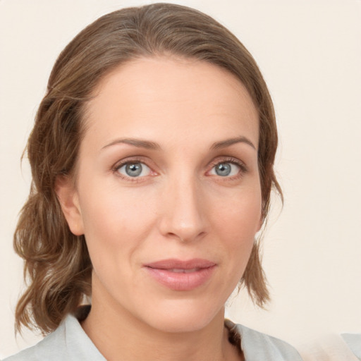 Joyful white young-adult female with medium  brown hair and blue eyes