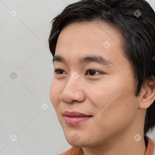 Joyful asian young-adult male with short  brown hair and brown eyes