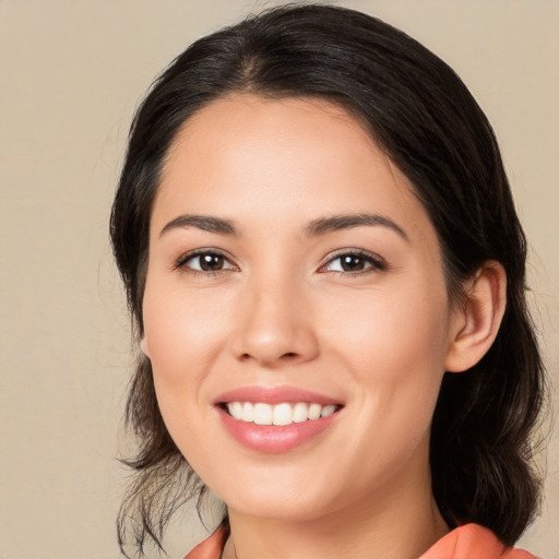 Joyful white young-adult female with medium  black hair and brown eyes