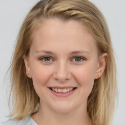 Joyful white child female with medium  brown hair and grey eyes