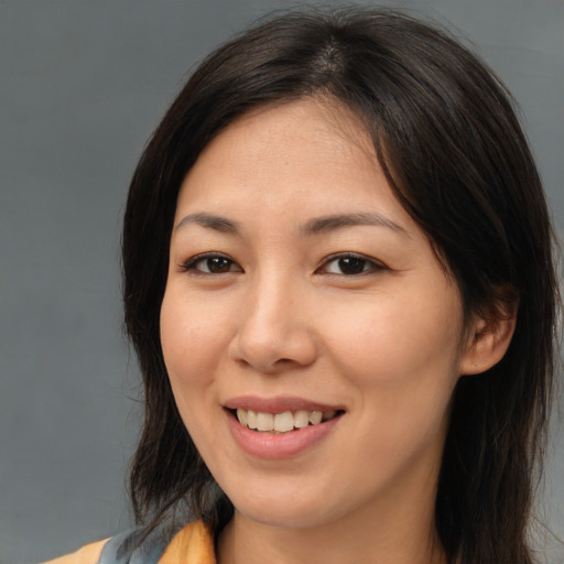 Joyful asian young-adult female with medium  brown hair and brown eyes