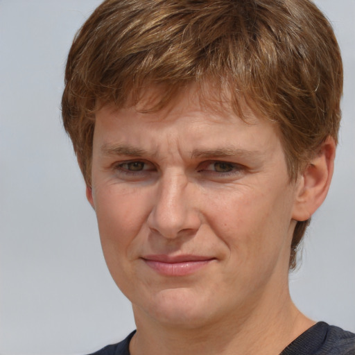 Joyful white adult male with short  brown hair and grey eyes