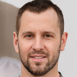 Joyful white adult male with short  brown hair and brown eyes