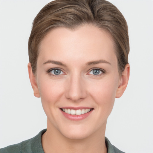 Joyful white young-adult female with short  brown hair and grey eyes