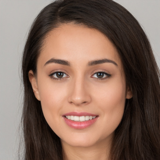 Joyful white young-adult female with long  brown hair and brown eyes