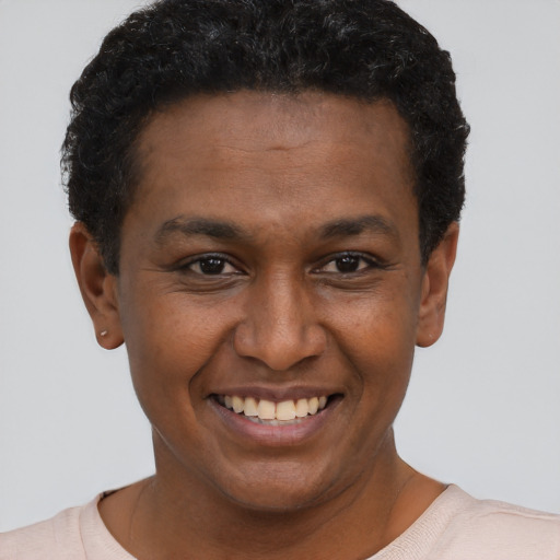 Joyful black young-adult male with short  brown hair and brown eyes