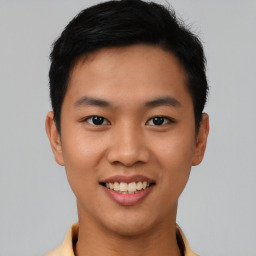 Joyful asian young-adult male with short  black hair and brown eyes