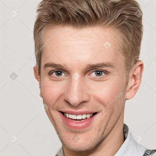 Joyful white adult male with short  brown hair and grey eyes