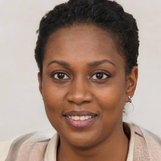 Joyful black young-adult female with short  brown hair and brown eyes