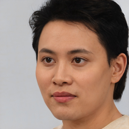 Joyful asian young-adult female with short  black hair and brown eyes