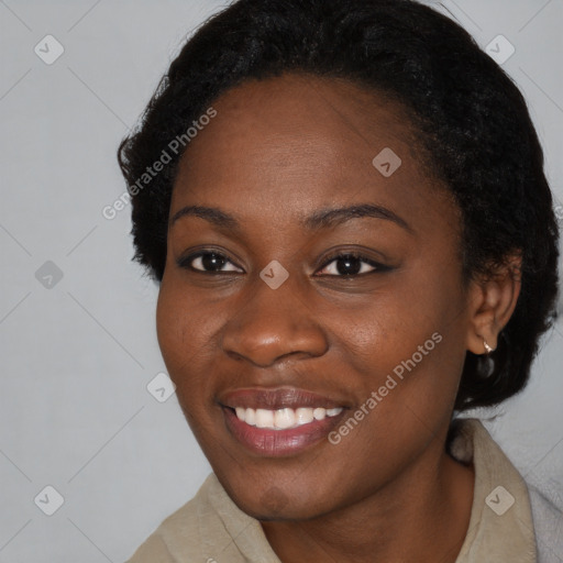 Joyful black young-adult female with short  black hair and brown eyes