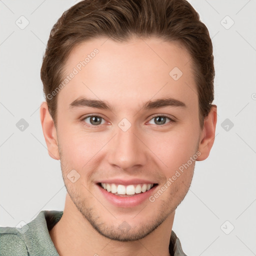 Joyful white young-adult male with short  brown hair and grey eyes