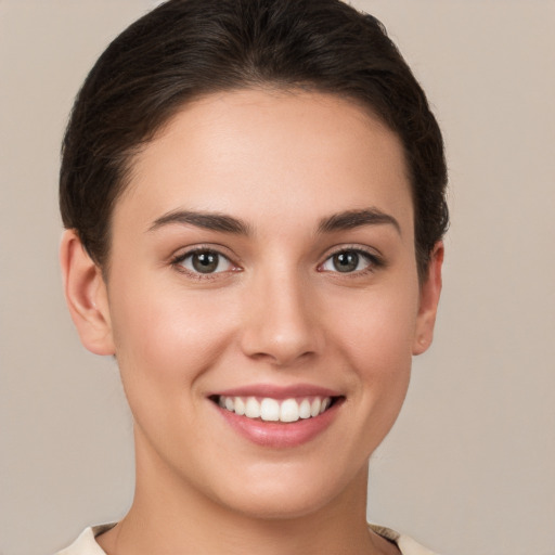 Joyful white young-adult female with short  brown hair and brown eyes