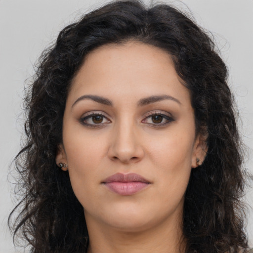 Joyful latino young-adult female with long  brown hair and brown eyes