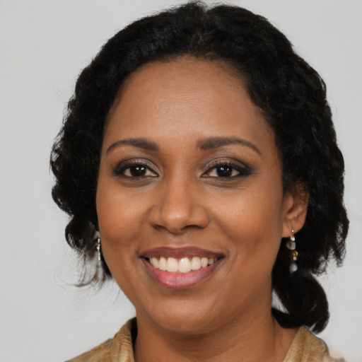 Joyful black young-adult female with medium  black hair and brown eyes