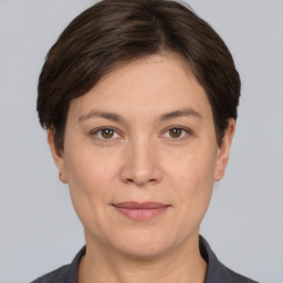 Joyful white adult female with short  brown hair and brown eyes