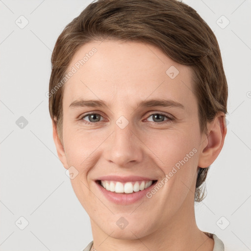 Joyful white young-adult female with short  brown hair and grey eyes