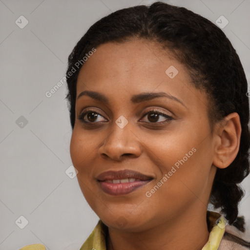 Joyful black young-adult female with short  brown hair and brown eyes