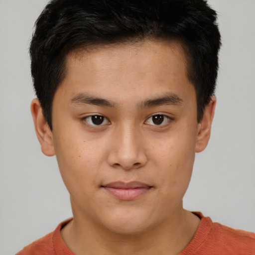 Joyful asian young-adult male with short  brown hair and brown eyes