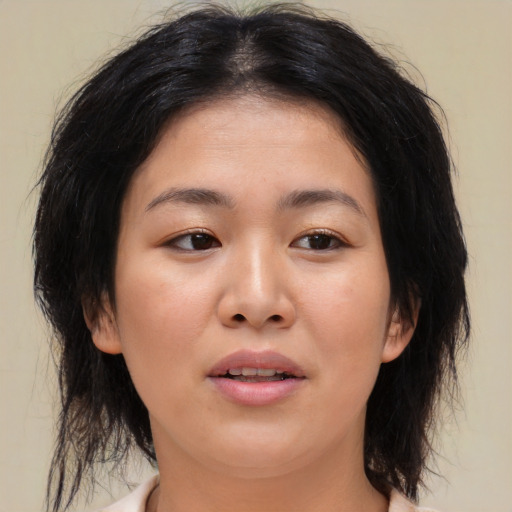 Joyful asian young-adult female with medium  brown hair and brown eyes
