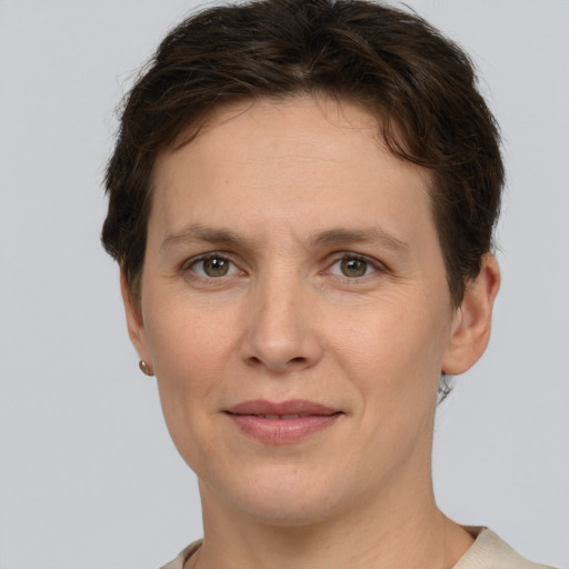 Joyful white adult female with short  brown hair and grey eyes